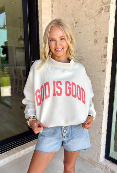 This heathered grey reversible pullover is the cozy, feel-good piece your summer evenings need! Designed with two meaningful looks in one, one side features “Jesus” in coral, while the other side is soft sherpa lined with “God Is Good” for an extra cozy vibe. The mock neck adds a polished touch, making it perfect for breezy nights, early mornings, or lounging in comfort. It’s the kind of piece that feels just as good as it looks—easy, meaningful, and made to wear on repeat. 