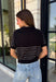 Get the layered look without the extra effort in this cozy short sleeve sweater. Featuring classic black and off white stripes, this knit is designed with an attached layered scarf detail that instantly elevates your outfit. The soft sweater knit keeps you cozy while the short sleeves make it perfect for transitioning through the season and layering under your favorite jackets. Finished with ribbed trim along the neckline, sleeves, and hem.