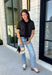 Get the layered look without the extra effort in this cozy short sleeve sweater. Featuring classic black and off white stripes, this knit is designed with an attached layered scarf detail that instantly elevates your outfit. The soft sweater knit keeps you cozy while the short sleeves make it perfect for transitioning through the season and layering under your favorite jackets. Finished with ribbed trim along the neckline, sleeves, and hem.