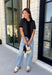 Get the layered look without the extra effort in this cozy short sleeve sweater. Featuring classic black and off white stripes, this knit is designed with an attached layered scarf detail that instantly elevates your outfit. The soft sweater knit keeps you cozy while the short sleeves make it perfect for transitioning through the season and layering under your favorite jackets. Finished with ribbed trim along the neckline, sleeves, and hem.