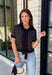 Get the layered look without the extra effort in this cozy short sleeve sweater. Featuring classic black and off white stripes, this knit is designed with an attached layered scarf detail that instantly elevates your outfit. The soft sweater knit keeps you cozy while the short sleeves make it perfect for transitioning through the season and layering under your favorite jackets. Finished with ribbed trim along the neckline, sleeves, and hem.