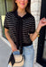 Get the layered look without the extra effort in this cozy short sleeve sweater. Featuring classic black and off white stripes, this knit is designed with an attached layered scarf detail that instantly elevates your outfit. The soft sweater knit keeps you cozy while the short sleeves make it perfect for transitioning through the season and layering under your favorite jackets. Finished with ribbed trim along the neckline, sleeves, and hem.
