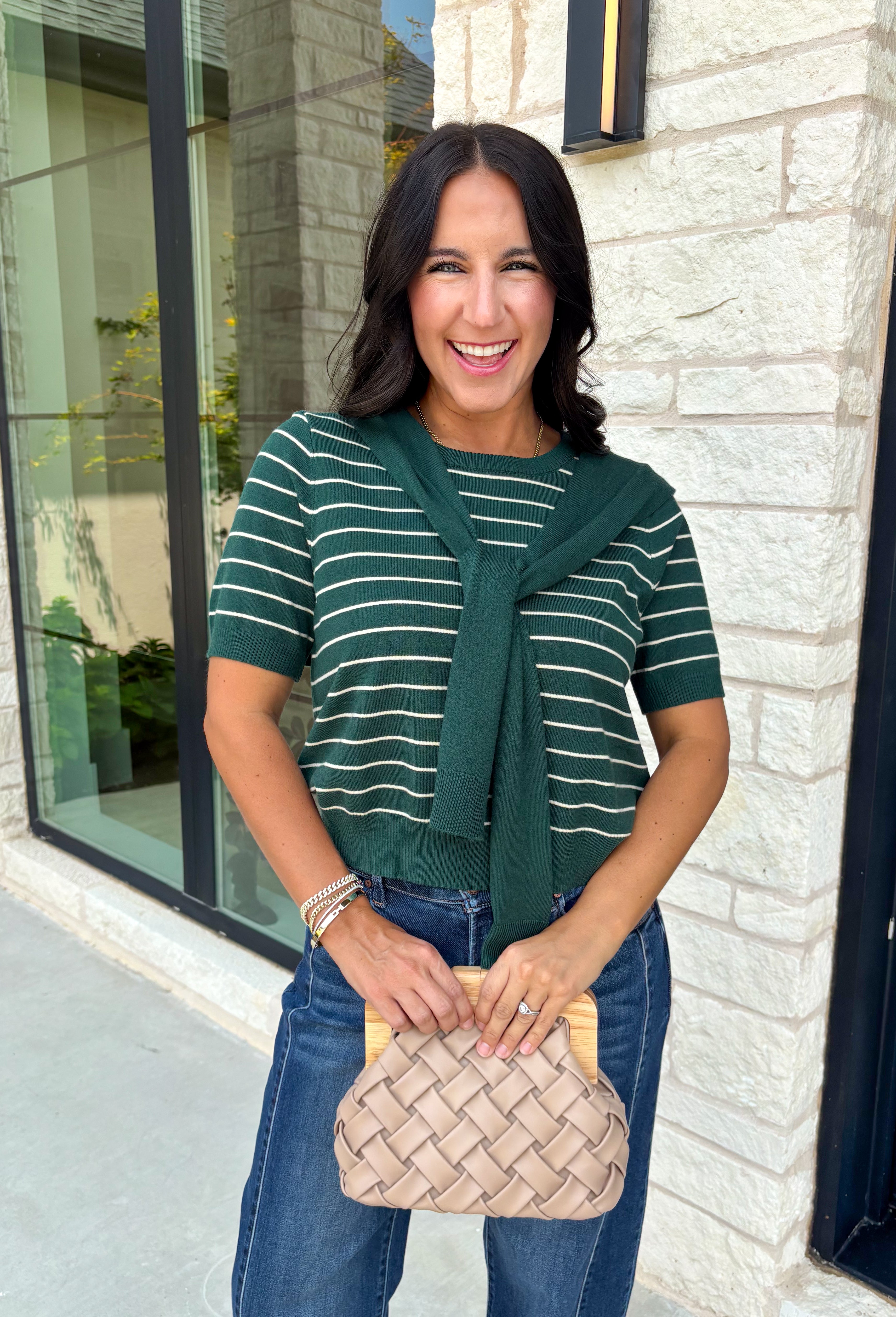 Get the layered look without the extra effort in this cozy short sleeve sweater. Featuring rich hunter green and off white stripes, this knit is designed with an attached layered scarf detail that instantly elevates your outfit. The soft sweater knit keeps you cozy while the short sleeves make it perfect for transitioning through the season and layering under your favorite jackets. 