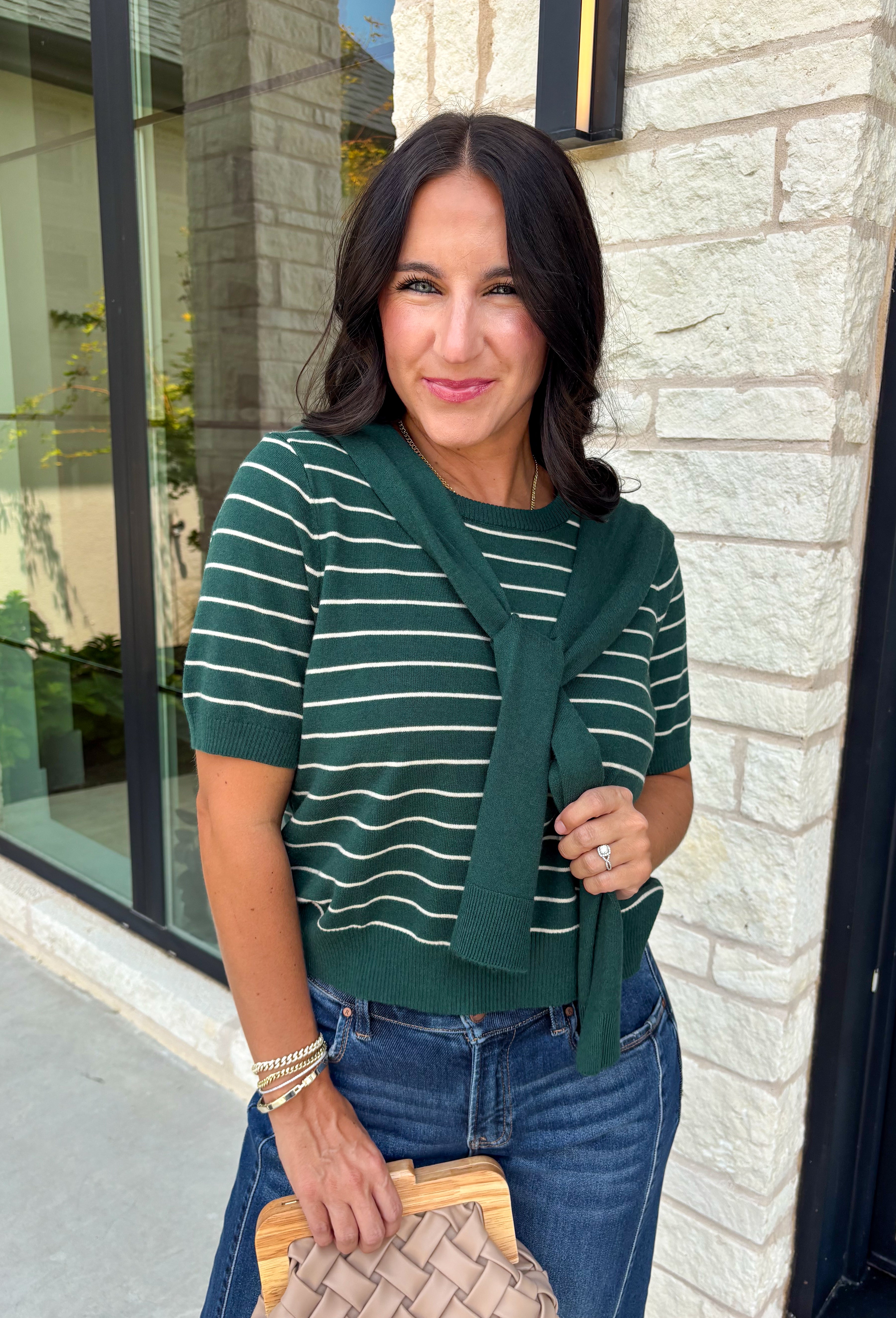 Get the layered look without the extra effort in this cozy short sleeve sweater. Featuring rich hunter green and off white stripes, this knit is designed with an attached layered scarf detail that instantly elevates your outfit. The soft sweater knit keeps you cozy while the short sleeves make it perfect for transitioning through the season and layering under your favorite jackets. 