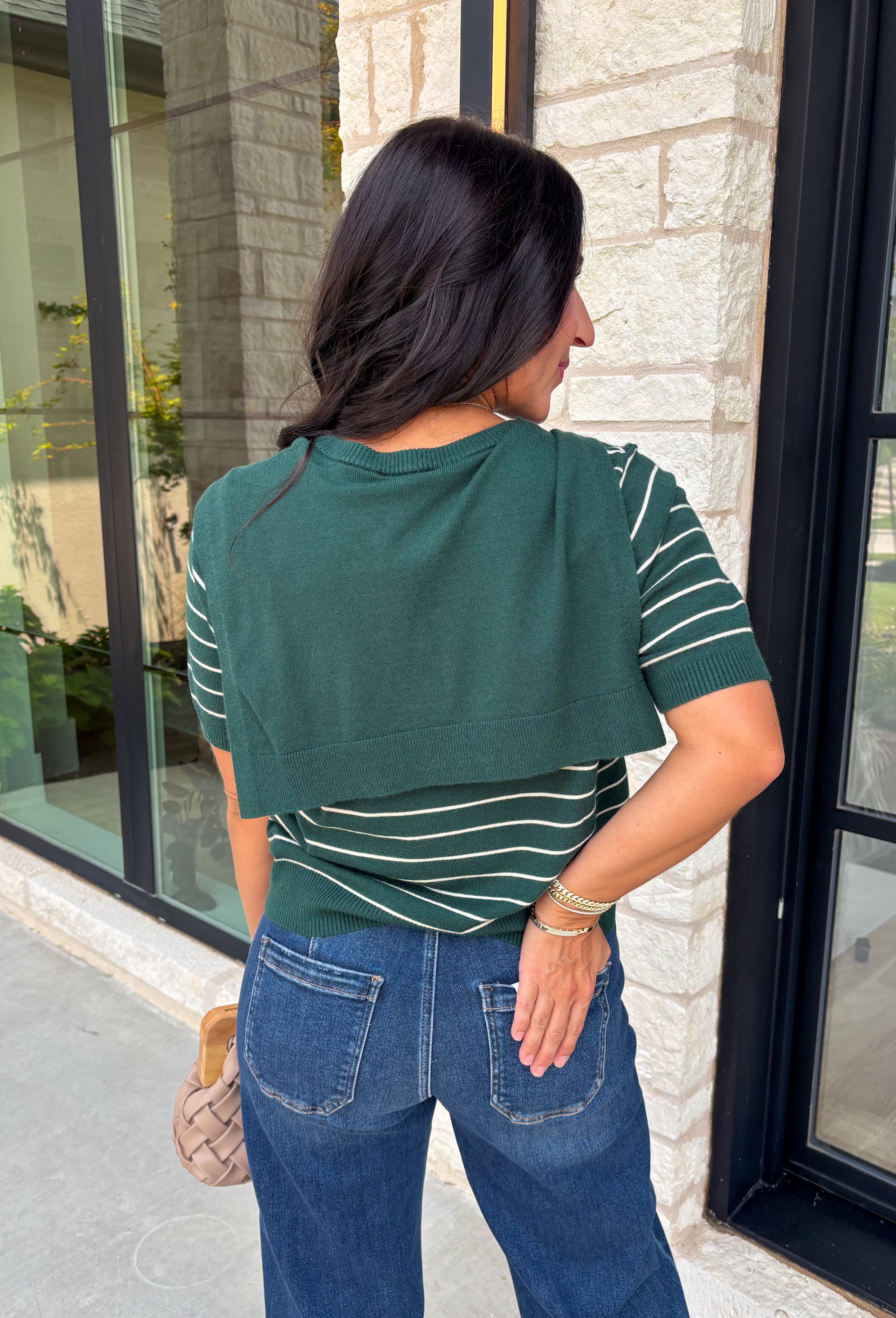 Get the layered look without the extra effort in this cozy short sleeve sweater. Featuring rich hunter green and off white stripes, this knit is designed with an attached layered scarf detail that instantly elevates your outfit. The soft sweater knit keeps you cozy while the short sleeves make it perfect for transitioning through the season and layering under your favorite jackets. 