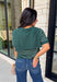 Get the layered look without the extra effort in this cozy short sleeve sweater. Featuring rich hunter green and off white stripes, this knit is designed with an attached layered scarf detail that instantly elevates your outfit. The soft sweater knit keeps you cozy while the short sleeves make it perfect for transitioning through the season and layering under your favorite jackets. 