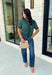 Get the layered look without the extra effort in this cozy short sleeve sweater. Featuring rich hunter green and off white stripes, this knit is designed with an attached layered scarf detail that instantly elevates your outfit. The soft sweater knit keeps you cozy while the short sleeves make it perfect for transitioning through the season and layering under your favorite jackets. 
