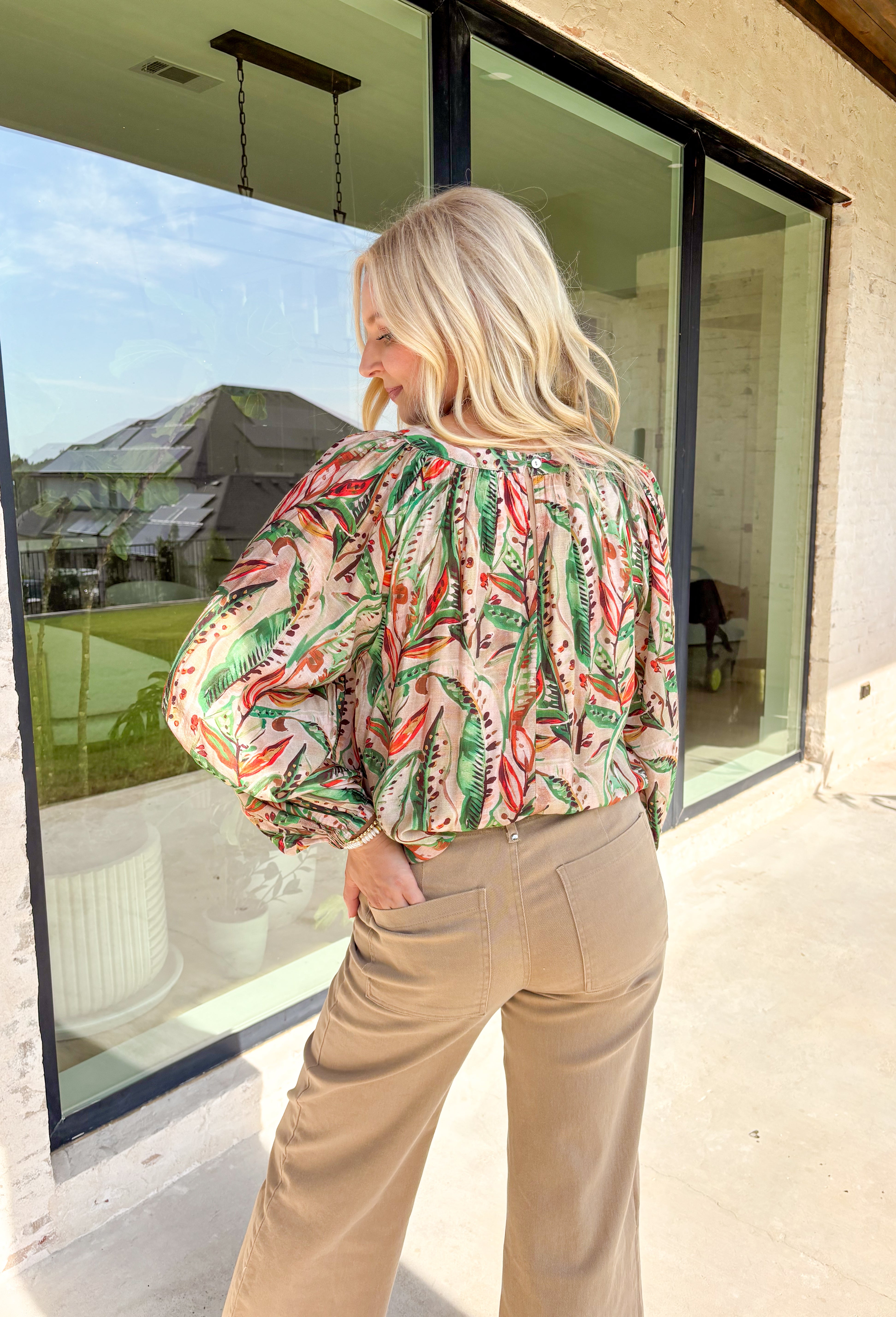 Make a statement this fall with a top that’s as bold as your favorite autumn latte. This neutral long sleeve blouse features a stunning mix of bold leaves and abstract floral patterns in rich seasonal shades of green, brown, orange, red, and tan. The balloon sleeves with elastic cuffs add a touch of drama while keeping things comfy and casual. It’s the perfect top for everything from the office to dinner with the girls.