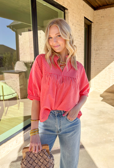 Sweet, playful, and perfect for Valentine’s Day, this red and pink mini gingham top by Wishlist is full of charm. The classic gingham print gives it that flirty, vintage-inspired feel, while the subtle ruffle neckline adds a soft, feminine touch. Lightweight and easy to style, it’s the kind of top you can wear for February plans and keep in rotation all spring long.