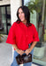Add a timeless staple to your wardrobe with this cozy cardigan from Double Zero. Designed in a rich red hue, this short sleeve knit is the perfect combination of classic style and everyday comfort. The button-front design makes it easy to wear on its own as a sweater or layered over your favorite basics, while the ribbed neckline adds a polished finishing touch. Soft, versatile, and easy to style, this cardigan is one you'll find yourself reaching for all season long.