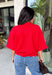 Add a timeless staple to your wardrobe with this cozy cardigan from Double Zero. Designed in a rich red hue, this short sleeve knit is the perfect combination of classic style and everyday comfort. The button-front design makes it easy to wear on its own as a sweater or layered over your favorite basics, while the ribbed neckline adds a polished finishing touch. Soft, versatile, and easy to style, this cardigan is one you'll find yourself reaching for all season long.