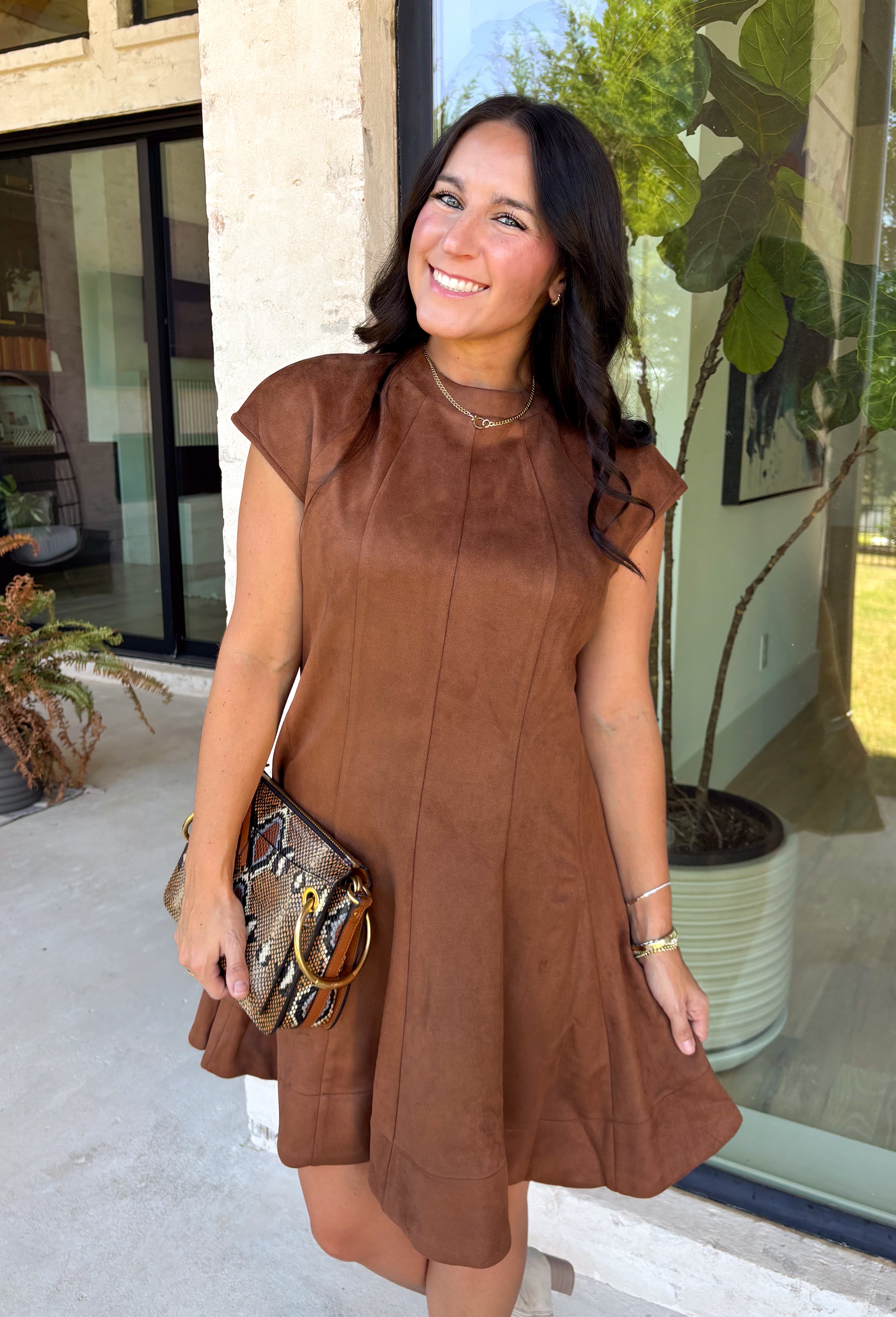 Holiday plans call for a dress that feels just as special as the occasion, and this brown faux suede dress from Fate is ready for every invite. The rich brown color and soft faux suede give it a warm seasonal look, while the structured paneled silhouette creates a flattering, defined shape. Vertical seaming through the bodice draws the eye to the fitted waist and hips before flowing into a flared A-line skirt. 
