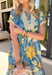 Bold, bright, and full of personality — this blue midi dress is made to stand out. The colorful floral print features shades of yellow, green, blue, and white, giving it that fresh, sunshine-ready feel. What makes it extra special? The contrasting abstract print in orange, pink, and blue along the front, sleeves, and hem for a playful pop of color that truly sets it apart. 