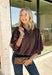 Meet the kind of top that makes getting dressed for the day feel easy. This solid top from Entro features a stand collar and partial button-front closure for a clean, classic look that works just as well at the office as it does for weekend plans. The ¾ balloon sleeves bring a little volume to the silhouette, while the elastic hem creates a flattering shape without needing to tuck it in. Lightweight and versatile, it’s an easy piece to pair with denim, trousers, or skirts throughout the fall season.