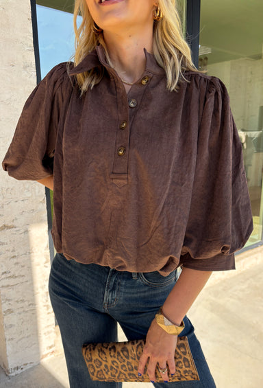 Meet the kind of top that makes getting dressed for the day feel easy. This solid top from Entro features a stand collar and partial button-front closure for a clean, classic look that works just as well at the office as it does for weekend plans. The ¾ balloon sleeves bring a little volume to the silhouette, while the elastic hem creates a flattering shape without needing to tuck it in. Lightweight and versatile, it’s an easy piece to pair with denim, trousers, or skirts throughout the fall season.