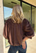 Meet the kind of top that makes getting dressed for the day feel easy. This solid top from Entro features a stand collar and partial button-front closure for a clean, classic look that works just as well at the office as it does for weekend plans. The ¾ balloon sleeves bring a little volume to the silhouette, while the elastic hem creates a flattering shape without needing to tuck it in. Lightweight and versatile, it’s an easy piece to pair with denim, trousers, or skirts throughout the fall season.