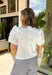 Crisp, fresh, and made for sunshine-filled days, this white short sleeve top is the kind of piece you’ll reach for on repeat all season long. The clean, classic silhouette gets an elevated twist with gorgeous white eyelet statement sleeves that add texture and just the right amount of feminine flair. Lightweight and breathable in 100% cotton, it’s easy, comfortable, and endlessly versatile. 
