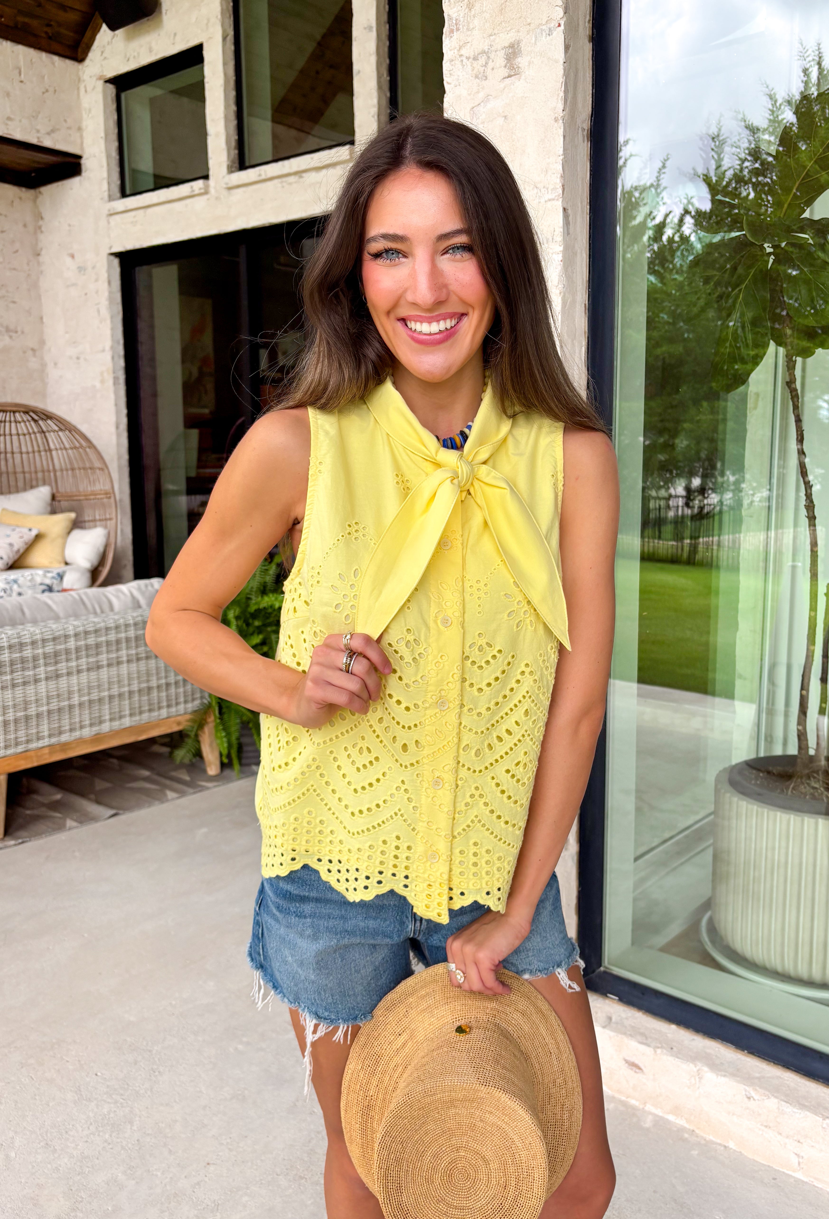 This lemon yellow sleeveless top is pure sunshine for your summer wardrobe! The bright, happy color instantly lifts your look, while the eyelet embroidery adds the prettiest touch of texture. The self-tie neckline brings a soft, feminine detail, and the scalloped hem gives it that extra something special. Designed with a button front and lightweight cotton fabric, it’s breathable and easy to wear all day long. Pair it with white denim or shorts for a fresh, standout outfit—this one is made for sunny days.