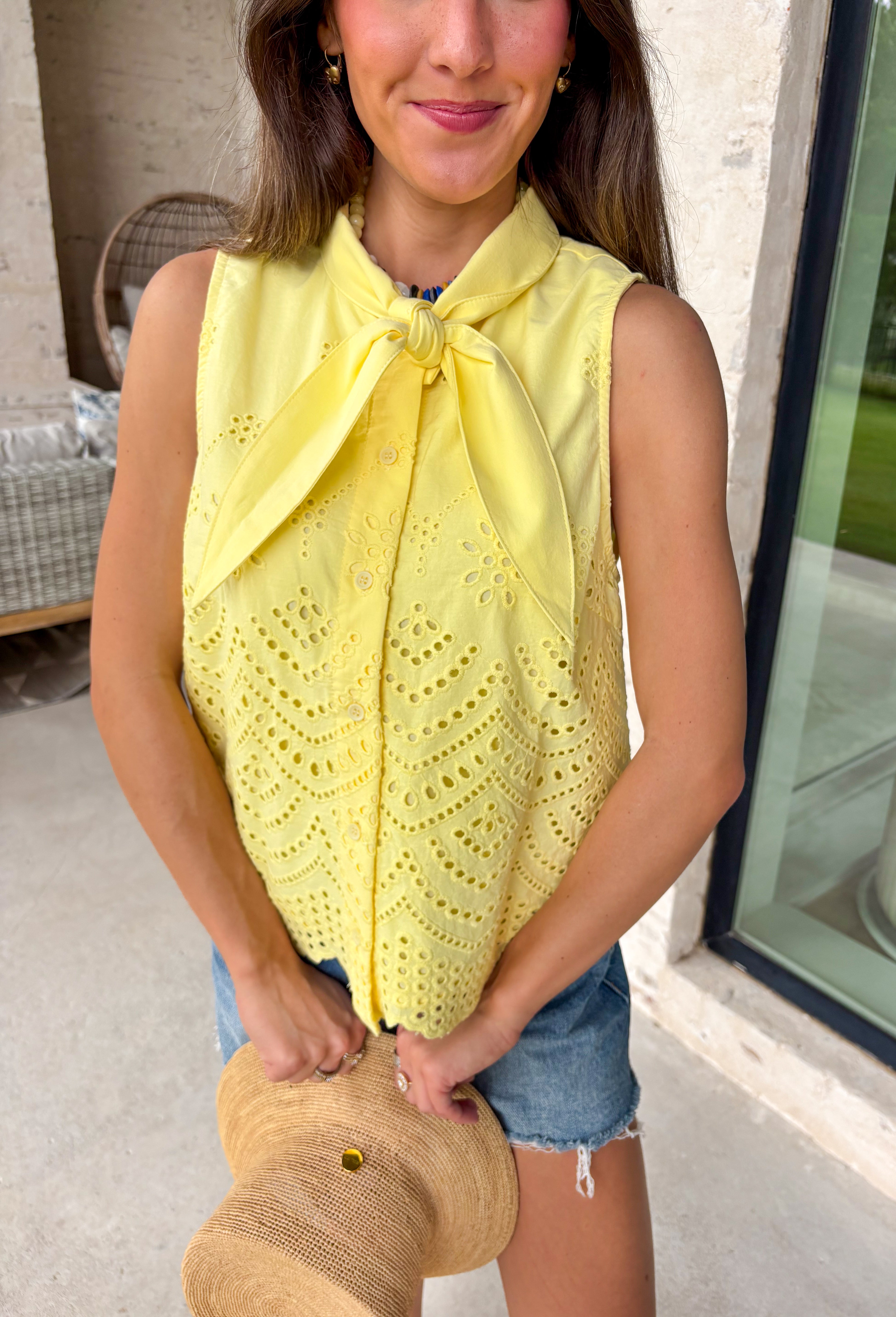 This lemon yellow sleeveless top is pure sunshine for your summer wardrobe! The bright, happy color instantly lifts your look, while the eyelet embroidery adds the prettiest touch of texture. The self-tie neckline brings a soft, feminine detail, and the scalloped hem gives it that extra something special. Designed with a button front and lightweight cotton fabric, it’s breathable and easy to wear all day long. Pair it with white denim or shorts for a fresh, standout outfit—this one is made for sunny days.