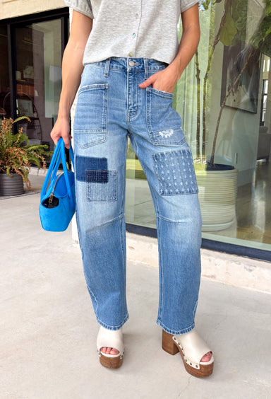 Your favorite barrel jeans are back in a fresh new style! These medium wash barrel jeans from Vervet feature the same flattering silhouette you already love, now updated with eye-catching patchwork detailing for an effortlessly cool, lived-in look. Crafted from comfortable stretch denim, they offer an easy fit that's perfect for everyday wear while adding a unique touch to any outfit. 