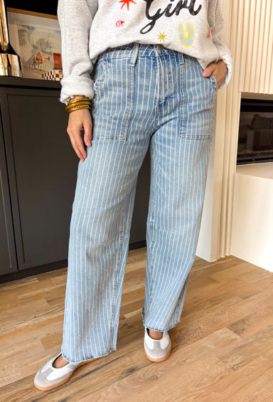 Your favorite Vervet barrel jean just got a fresh new update. This medium wash high rise denim features a white pinstripe print that adds the perfect touch of polish while keeping that relaxed, on-trend barrel silhouette we all love. The high rise fit flatters and holds you in, while the inseam makes it easy to style with everything from sneakers to sandals. With just the right amount of stretch, these jeans are comfortable enough for all-day wear but structured enough to keep their shape. 