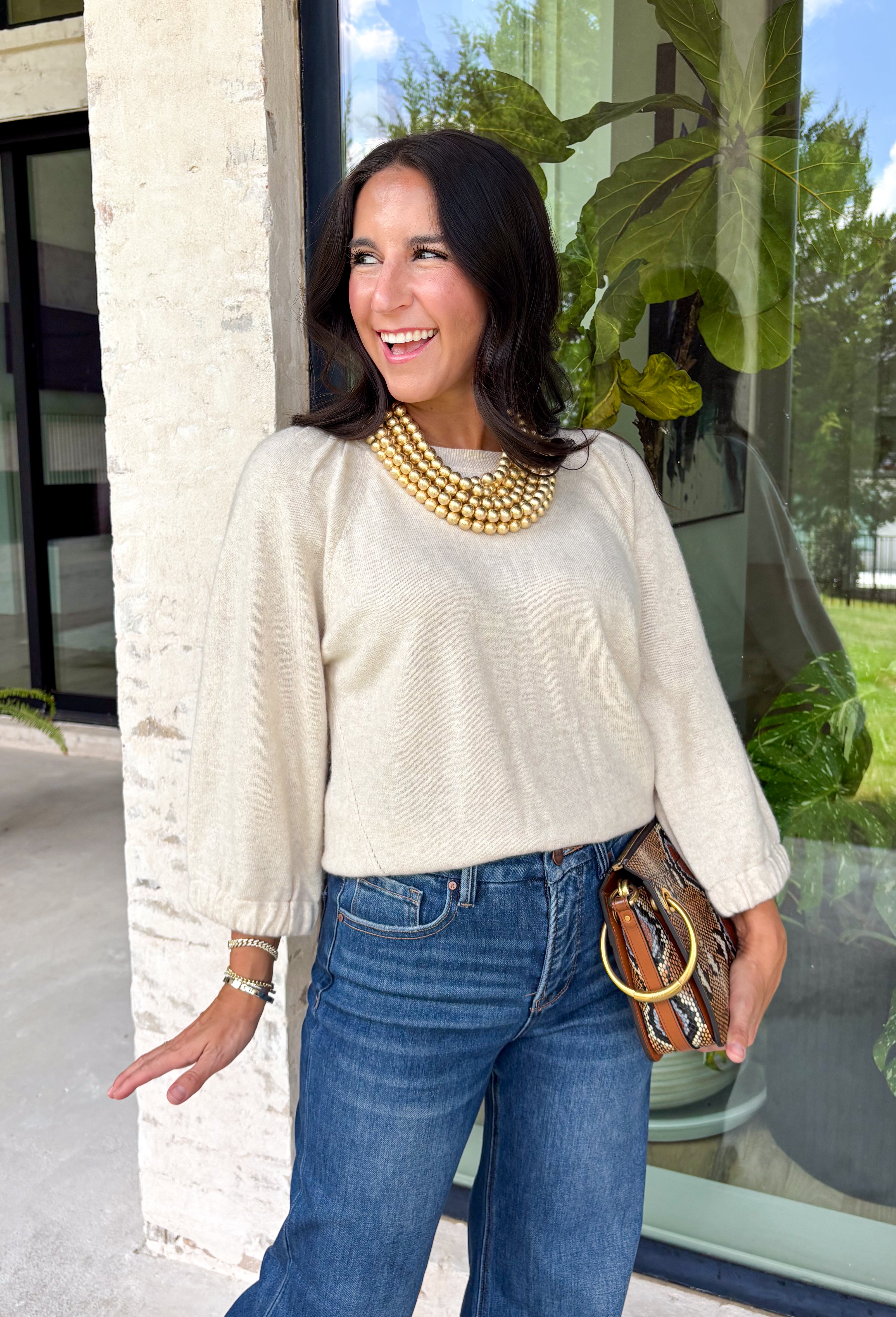 Nothing says cozy season quite like the perfect neutral sweater. Crafted in a soft oatmeal hue, this elevated knit is designed with beautifully oversized sleeves that create a relaxed, effortlessly chic silhouette. The ribbed neckline and hem add timeless structure, while the elastic cuffs give the sleeves a soft, billowy shape.