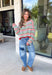 Cozy season gets a colorful update with this cream open knit sweater from Hyfve. The neutral cream base is woven with playful pops of red, blue, green, and black, giving it plenty of personality while still keeping it easy to mix and match. The open knit design creates a textured look that’s perfect for layering as those crisp fall days start turning colder. 