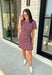 From busy weekdays to weekend plans, this striped dress is the effortless piece you'll find yourself reaching for again and again! Designed with classic plum and tan stripes, this lightweight dress offers the perfect mix of comfort and polished style for the season. The adjustable self-tie waist creates a flattering silhouette, while the contrast ribbed neckline and sleeve cuffs add a sporty-chic touch that makes this dress stand out. 