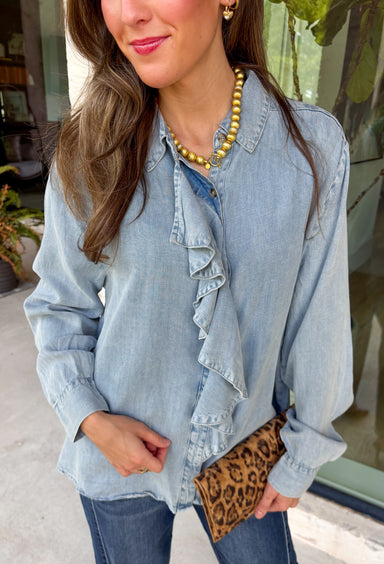 A timeless chambray top is a wardrobe staple you'll reach for season after season. Crafted in a soft light wash lyocell fabric, this effortlessly feminine button-down combines classic style with delicate details you'll love. The subtle ruffle trim adds a romantic touch to the polished collared neckline, creating a look that's both refined and easy to wear.