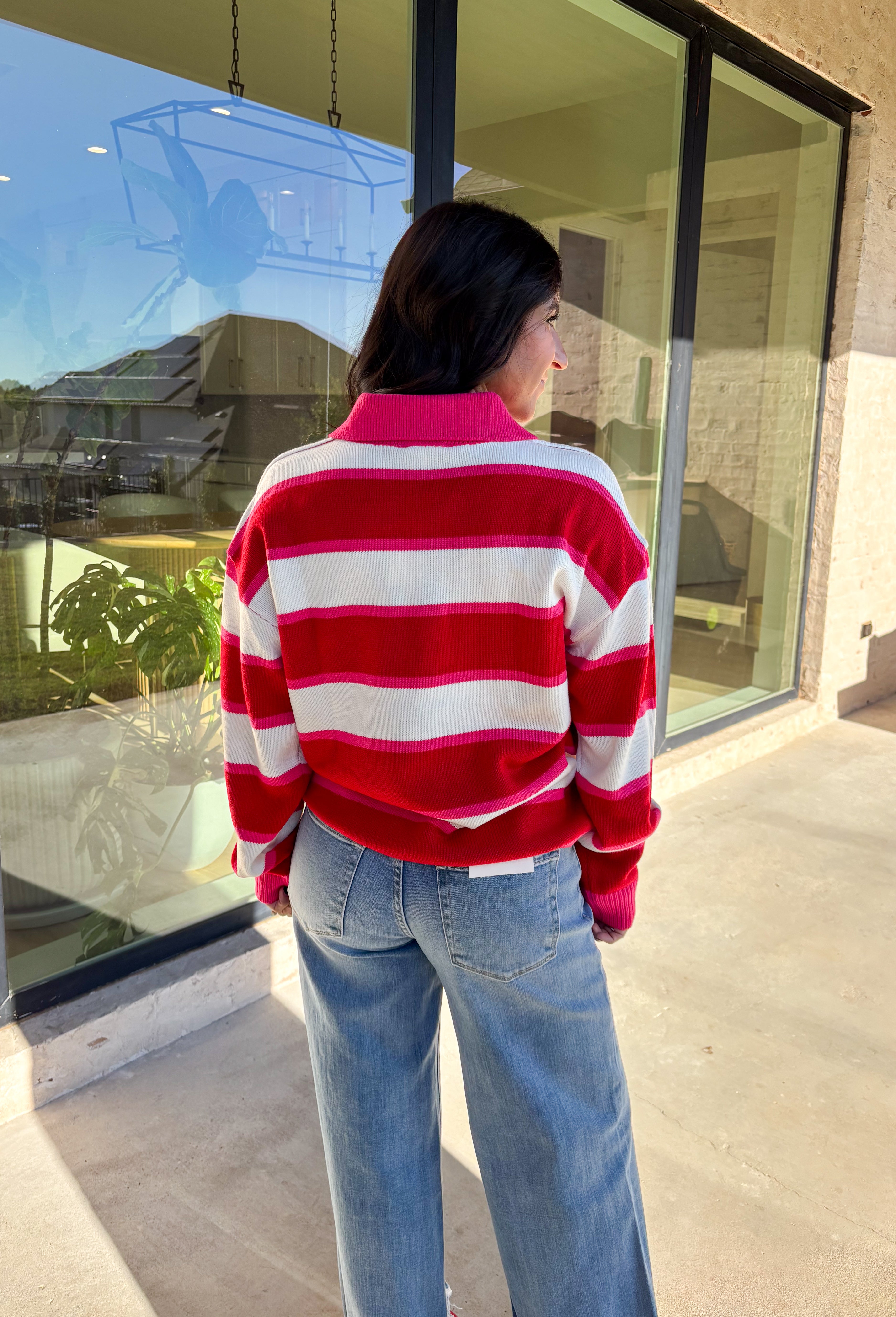 This striped sweater is giving retro prep meets pumpkin spice—and we’re here for it. With bold red, playful pink, and classic white stripes, it brings a cheerful twist to gloomy fall days. The collared neckline and front button details add a polished touch that feels just right for layering over your favorite jeans or corduroy skirt. Made from soft, cozy acrylic, it’s a lightweight piece that still keeps you warm on crisp autumn mornings. Whether you’re headed to the office or a cider-sipping weekend, this 