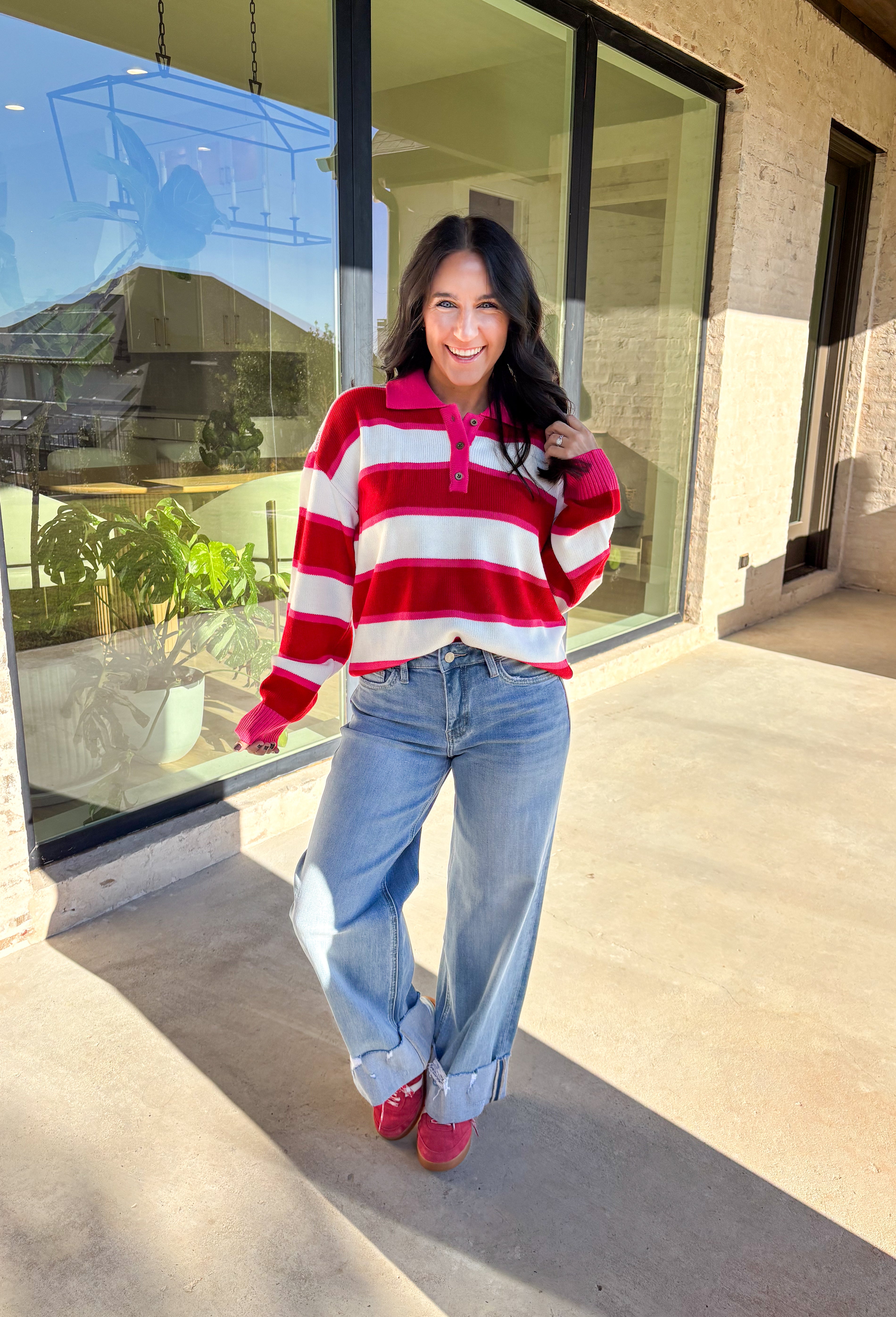 This striped sweater is giving retro prep meets pumpkin spice—and we’re here for it. With bold red, playful pink, and classic white stripes, it brings a cheerful twist to gloomy fall days. The collared neckline and front button details add a polished touch that feels just right for layering over your favorite jeans or corduroy skirt. Made from soft, cozy acrylic, it’s a lightweight piece that still keeps you warm on crisp autumn mornings. Whether you’re headed to the office or a cider-sipping weekend, this 