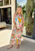 Easy, breezy, and full of personality — this sleeveless neutral midi dress is a true standout. The colorful abstract print in pink, yellow, green, and blue brings a playful pop to the soft neutral base, making it perfect for sunny days and special moments alike. A self-tie bow detail on one strap adds the sweetest feminine touch, while the subtle ruffle neckline keeps the look soft and flattering. 