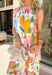 Easy, breezy, and full of personality — this sleeveless neutral midi dress is a true standout. The colorful abstract print in pink, yellow, green, and blue brings a playful pop to the soft neutral base, making it perfect for sunny days and special moments alike. A self-tie bow detail on one strap adds the sweetest feminine touch, while the subtle ruffle neckline keeps the look soft and flattering. 