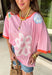 This pink floral top is full of those pretty little details that make summer outfits feel extra special! Featuring a colorful floral print with embroidered accents and white eyelet detailing, it has the perfect mix of texture and charm. The coral trim along the neckline and sleeves adds a fun pop of contrast that really makes it stand out. Lightweight and breathable in 100% cotton, it’s perfect for warm days when you want something easy but still eye-catching. 