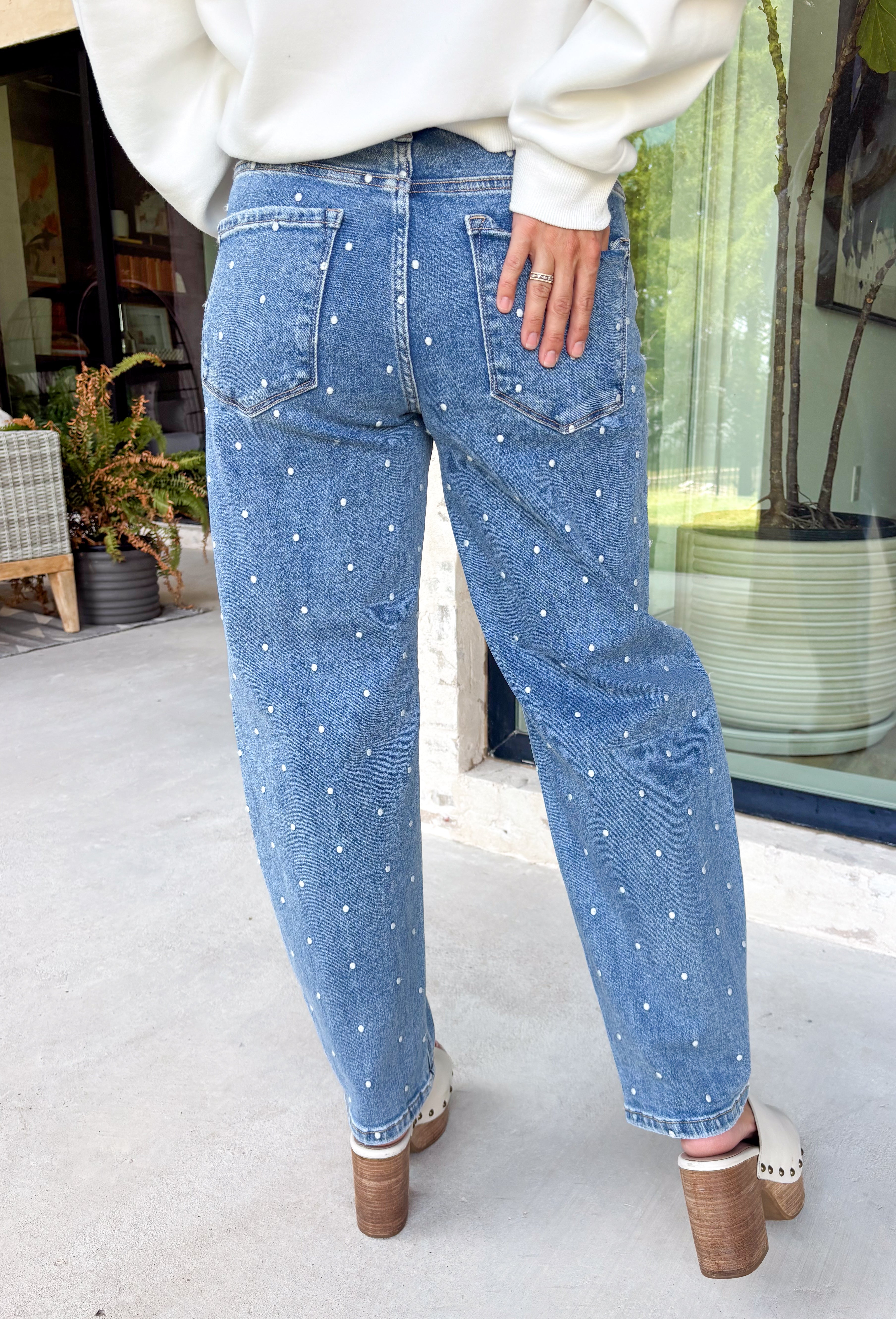 Add a playful twist to your everyday denim with these standout barrel jeans from Risen. Designed in a classic medium wash, these high-rise cropped jeans feature embroidered polka dots throughout for a fun, feminine detail that's easy to wear. The on-trend barrel leg silhouette creates a relaxed yet flattering fit, while the comfortable stretch fabric keeps you feeling great from morning to night. 