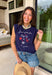 This navy graphic tank is made for celebrating summer and everything that comes with it! Featuring “Land Of The Free Because Of The Brave” with red, white, and blue star details, it brings the perfect patriotic touch for the 4th of July and beyond. The mix of printed and embroidered elements adds dimension and makes it feel extra special. Lightweight and breathable in 100% cotton, it’s perfect for warm days filled with BBQs, fireworks, and time with friends and family. 