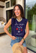 This navy graphic tank is made for celebrating summer and everything that comes with it! Featuring “Land Of The Free Because Of The Brave” with red, white, and blue star details, it brings the perfect patriotic touch for the 4th of July and beyond. The mix of printed and embroidered elements adds dimension and makes it feel extra special. Lightweight and breathable in 100% cotton, it’s perfect for warm days filled with BBQs, fireworks, and time with friends and family. 