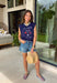 This navy graphic tank is made for celebrating summer and everything that comes with it! Featuring “Land Of The Free Because Of The Brave” with red, white, and blue star details, it brings the perfect patriotic touch for the 4th of July and beyond. The mix of printed and embroidered elements adds dimension and makes it feel extra special. Lightweight and breathable in 100% cotton, it’s perfect for warm days filled with BBQs, fireworks, and time with friends and family. 