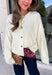 A classic cardigan is a wardrobe staple you'll wear year after year, and this timeless style from Double Zero is the perfect addition to your collection. Designed in a soft cream knit, this cozy cardigan features beautiful tortoise buttons that add a warm, elevated touch to its classic silhouette. Ribbed detailing at the neckline, hem, and cuffs creates a polished finish, while the soft knit keeps you comfortable all day long. 