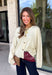 A classic cardigan is a wardrobe staple you'll wear year after year, and this timeless style from Double Zero is the perfect addition to your collection. Designed in a soft cream knit, this cozy cardigan features beautiful tortoise buttons that add a warm, elevated touch to its classic silhouette. Ribbed detailing at the neckline, hem, and cuffs creates a polished finish, while the soft knit keeps you comfortable all day long. 
