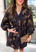 Step into the season with effortless style in this beautifully detailed dress from Entro. Designed with a classic black backdrop and a rich floral print in shades of brown and tan, this timeless dress captures the warmth of fall with every detail. The flattering v-neckline and button-front design create a polished silhouette, while the included matching belt defines the waist for a customizable fit. Finished with ¾ balloon sleeves, a playful ruffle hem, convenient side pockets.