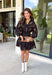 Step into the season with effortless style in this beautifully detailed dress from Entro. Designed with a classic black backdrop and a rich floral print in shades of brown and tan, this timeless dress captures the warmth of fall with every detail. The flattering v-neckline and button-front design create a polished silhouette, while the included matching belt defines the waist for a customizable fit. Finished with ¾ balloon sleeves, a playful ruffle hem, convenient side pockets.