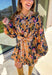 Bring bold fall energy to your wardrobe with this navy long sleeve dress featuring a colorful floral print in rich autumn shades. A playful orange plaid self-tie belt cinches the waist for a flattering finish, while striped piping throughout ties the look together with unique detail. The elastic cuff sleeves keep the fit comfortable, and the lightweight fabric makes it easy to wear through the season. Effortlessly fun and polished, this dress is a perfect choice for fall outings and gatherings.