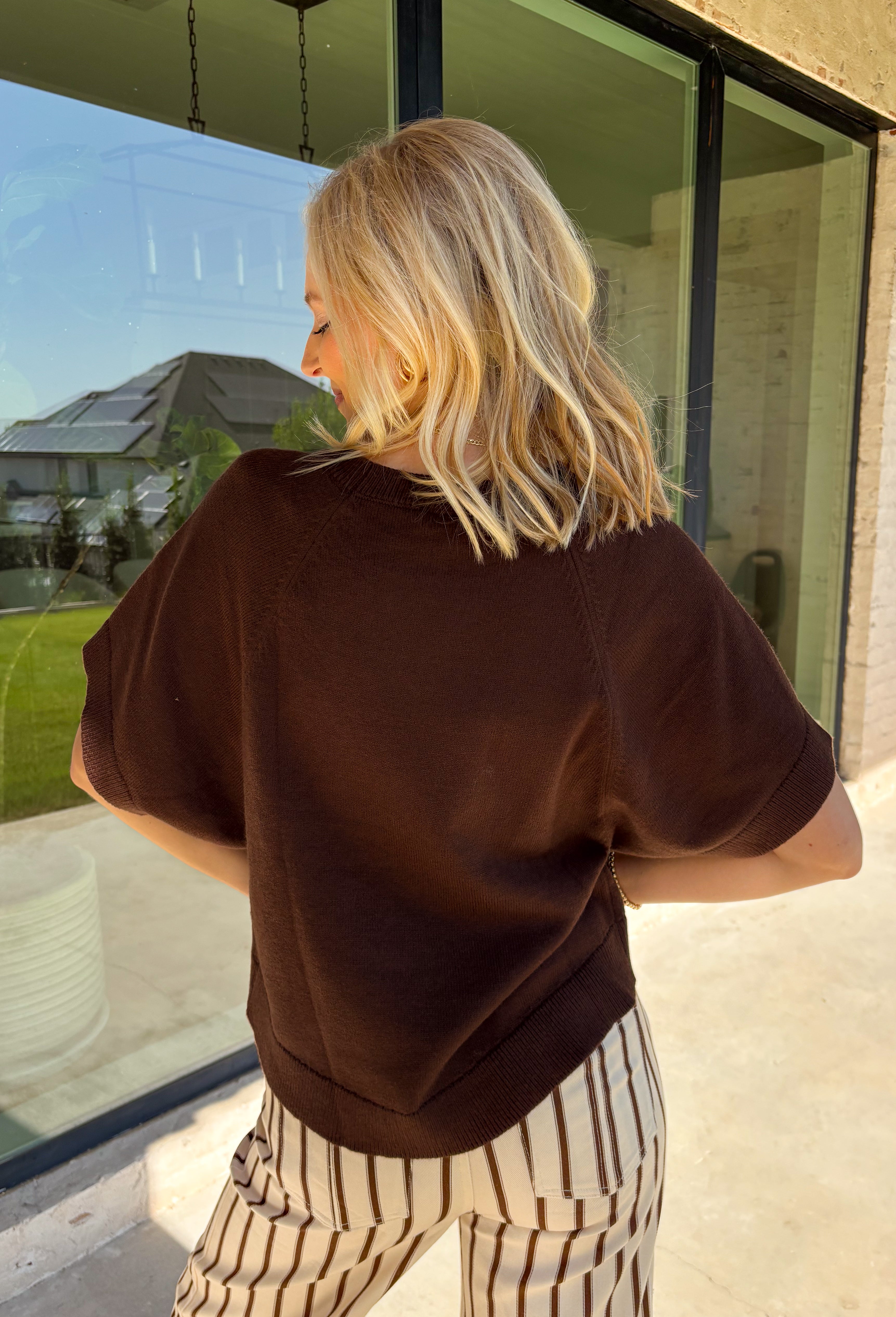 Wrap yourself in effortless fall style with this cozy brown short sleeve sweater! The rich autumn hue makes it a staple you'll reach for again and again, while the relaxed dolman sleeves create an easy, comfortable fit that's both flattering and timeless. Wide ribbed sleeve bands, a classic ribbed round neckline, and a ribbed hem add elevated finishing touches to this versatile knit. 
