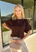 Wrap yourself in effortless fall style with this cozy brown short sleeve sweater! The rich autumn hue makes it a staple you'll reach for again and again, while the relaxed dolman sleeves create an easy, comfortable fit that's both flattering and timeless. Wide ribbed sleeve bands, a classic ribbed round neckline, and a ribbed hem add elevated finishing touches to this versatile knit. 