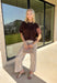 Wrap yourself in effortless fall style with this cozy brown short sleeve sweater! The rich autumn hue makes it a staple you'll reach for again and again, while the relaxed dolman sleeves create an easy, comfortable fit that's both flattering and timeless. Wide ribbed sleeve bands, a classic ribbed round neckline, and a ribbed hem add elevated finishing touches to this versatile knit. 