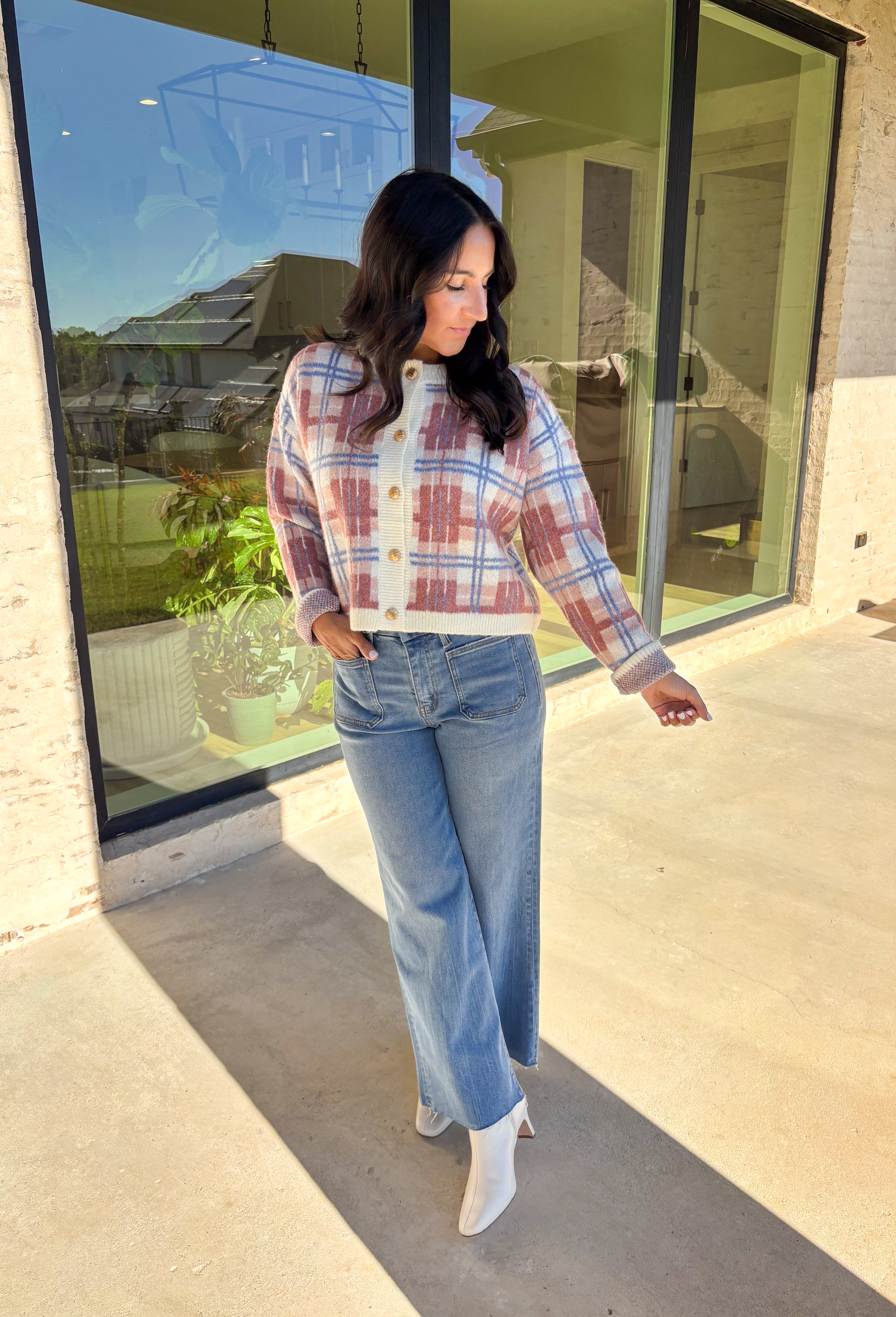 Plaid meets cozy charm in this cropped button-down cardigan. Designed in cream, blue, dark pink, and light pink, it’s the perfect pop of color for cooler days. Gold textured buttons add a polished detail, while the soft knit blend makes it extra comfortable. With its cropped fit and long sleeves, this cardigan is easy to style layered over a cami, tee, or even a dress for that just-right fall look.