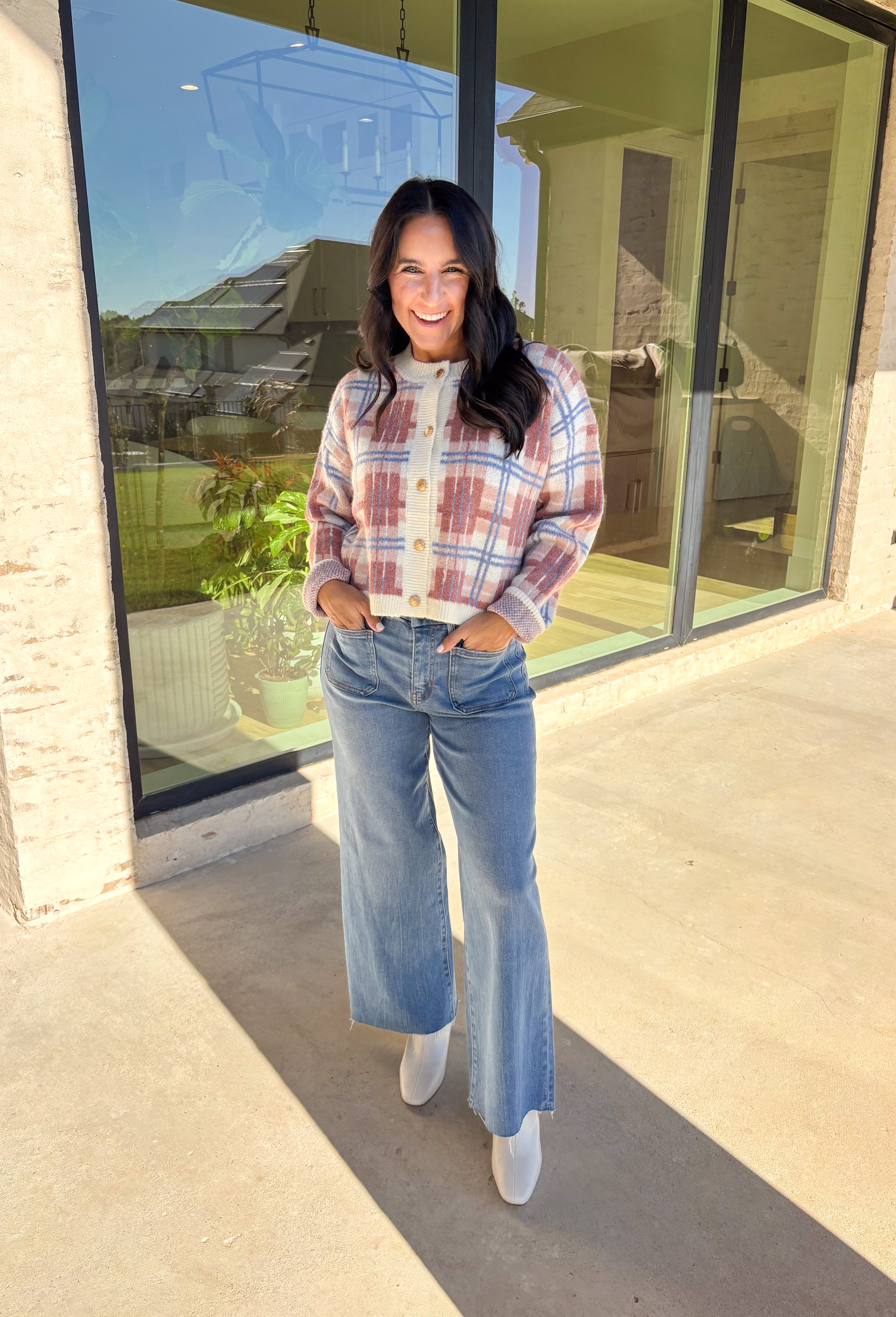 Plaid meets cozy charm in this cropped button-down cardigan. Designed in cream, blue, dark pink, and light pink, it’s the perfect pop of color for cooler days. Gold textured buttons add a polished detail, while the soft knit blend makes it extra comfortable. With its cropped fit and long sleeves, this cardigan is easy to style layered over a cami, tee, or even a dress for that just-right fall look.