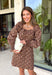A classic leopard print never goes out of style, and this stunning dress is the perfect way to wear it this season. Designed with an effortlessly flattering silhouette, this timeless piece features a feminine square neckline and a beautiful open-back tie detail for an elevated touch. The smocked back provides a comfortable, flexible fit, while the long sleeves with smocked cuffs add soft volume and charm. 