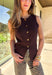 Classic meets modern in this sleeveless brown sweater by Iris. The button-down design is elevated with gold hammered buttons that add a chic, statement touch. Crafted in a soft knit with a lightweight feel, it’s perfect for layering under jackets or wearing solo on warmer days. A versatile piece that easily transitions from casual outings to dressier occasions.
